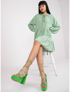 Fashionhunters Světle zelené šaty ve stylu boho s volánem