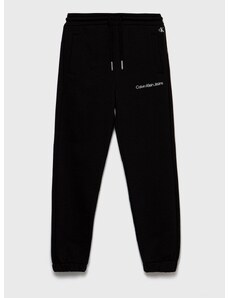 Dětské tepláky Calvin Klein Jeans černá barva, hladké