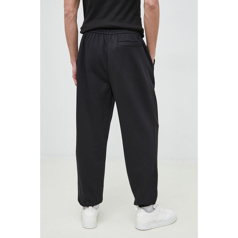 Tepláky Calvin Klein Jeans černá barva, s aplikací