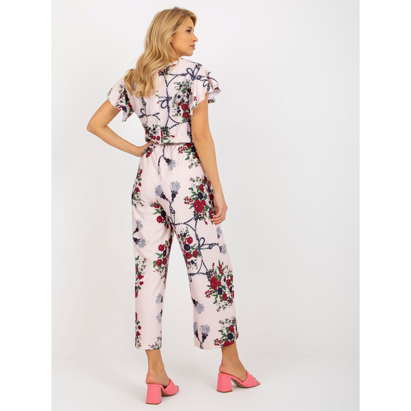 Fashionhunters Světle růžový květovaný overal se širokými nohavicemi