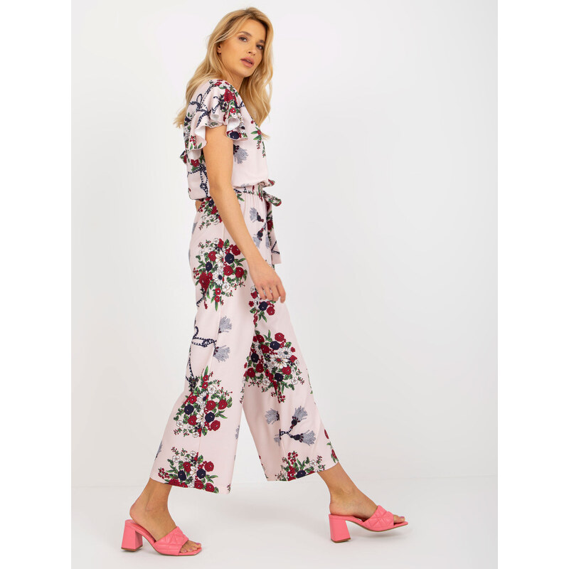 Fashionhunters Světle růžový květovaný overal se širokými nohavicemi