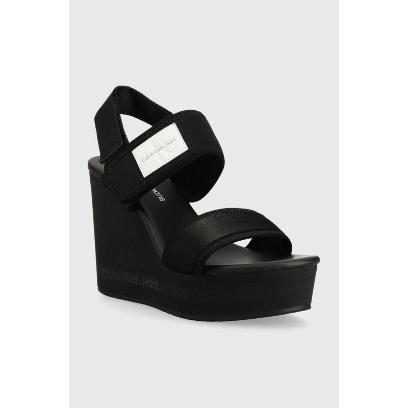 Sandály Calvin Klein Jeans WEDGE SANDAL BADGE dámské, černá barva, na klínku, YW0YW01028