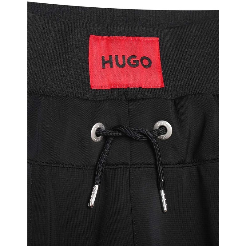 Dětské tepláky HUGO černá barva, s aplikací