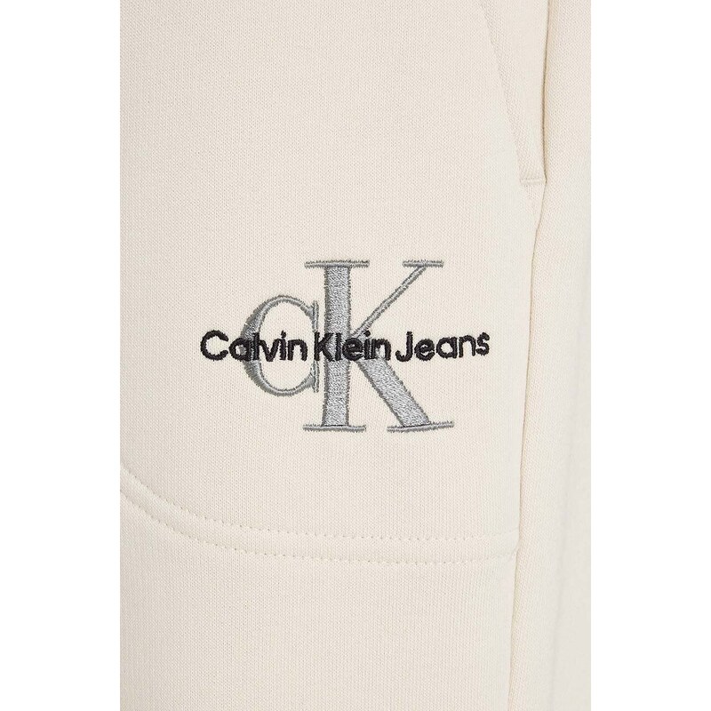 Dětské tepláky Calvin Klein Jeans béžová barva, hladké