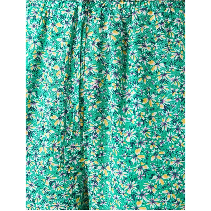 Koton Floral Mini Shorts that are tied at the waist with pockets.