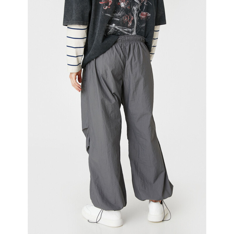 Koton Parachute Trousers with a loose fit, lacing at the waist, and elasticated legs with a pocket detail.