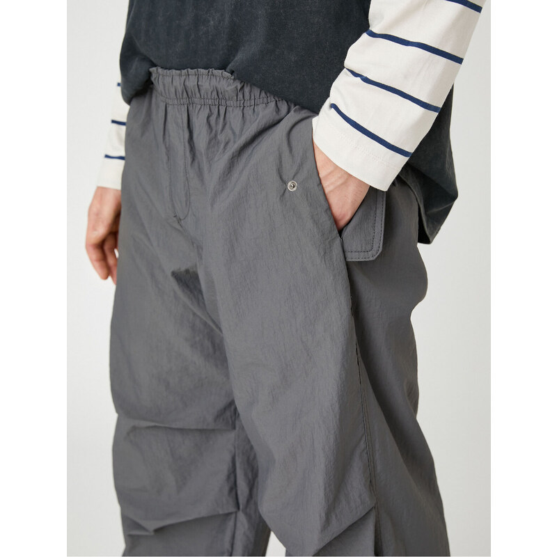 Koton Parachute Trousers with a loose fit, lacing at the waist, and elasticated legs with a pocket detail.