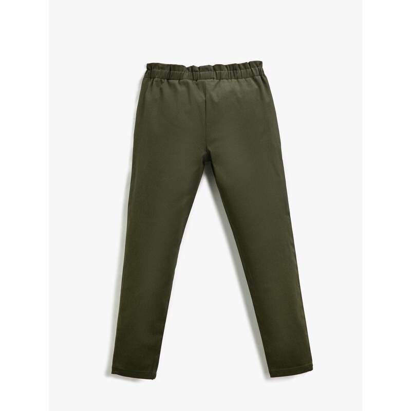 Koton Fabric Carrot Trousers with Button Detail Pocket.
