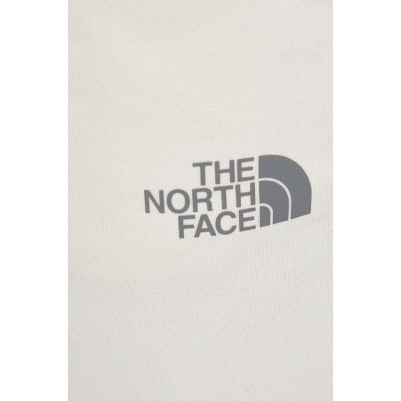 Bavlněné tepláky The North Face béžová barva, s potiskem, NF0A87DMQLI1