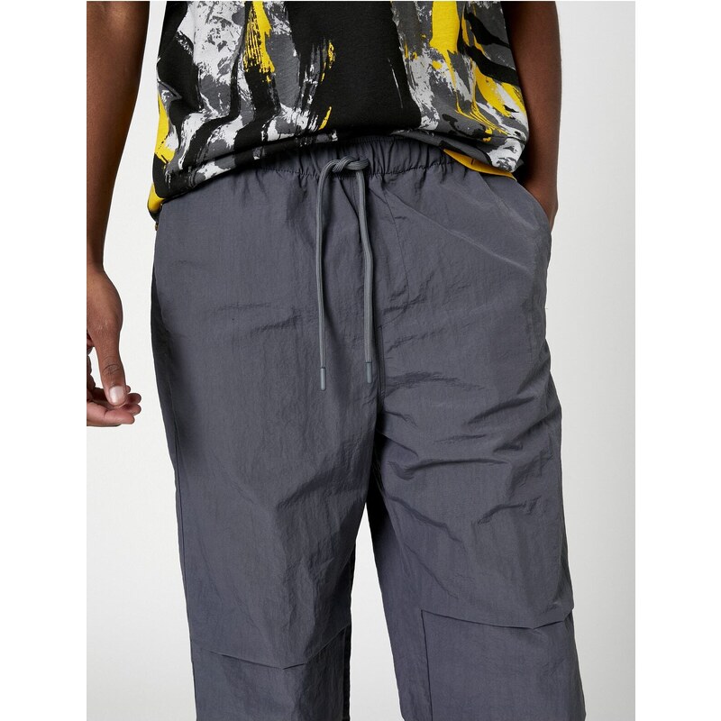 Koton Parachute Trousers with a loose fit, lacing at the waist, and elasticated legs with a pocket detail.