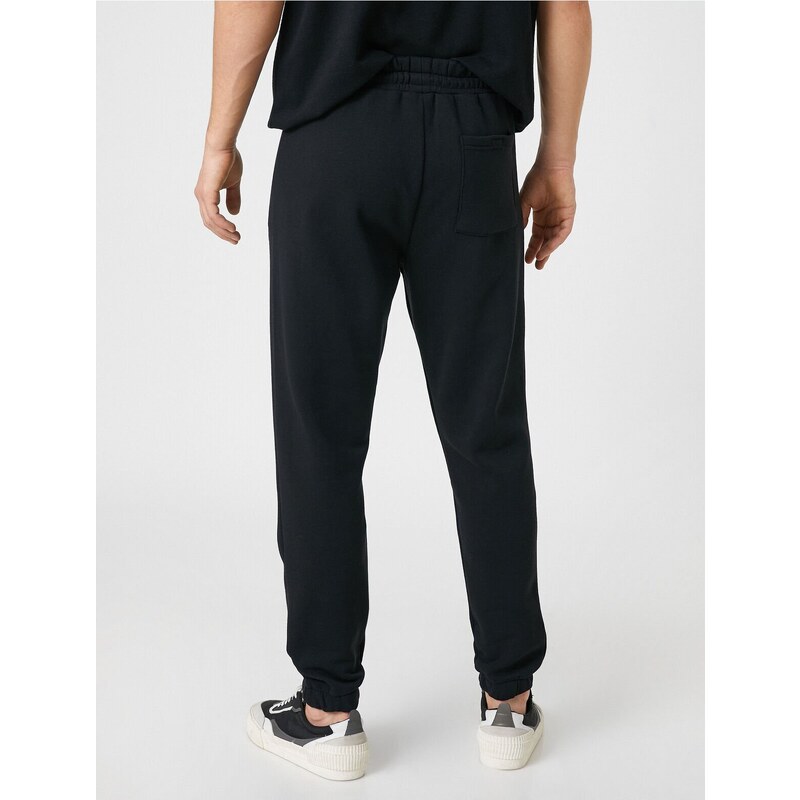 Koton Jogger Sweatpants with a skull print, zippered pockets, Lace-Up Waist.