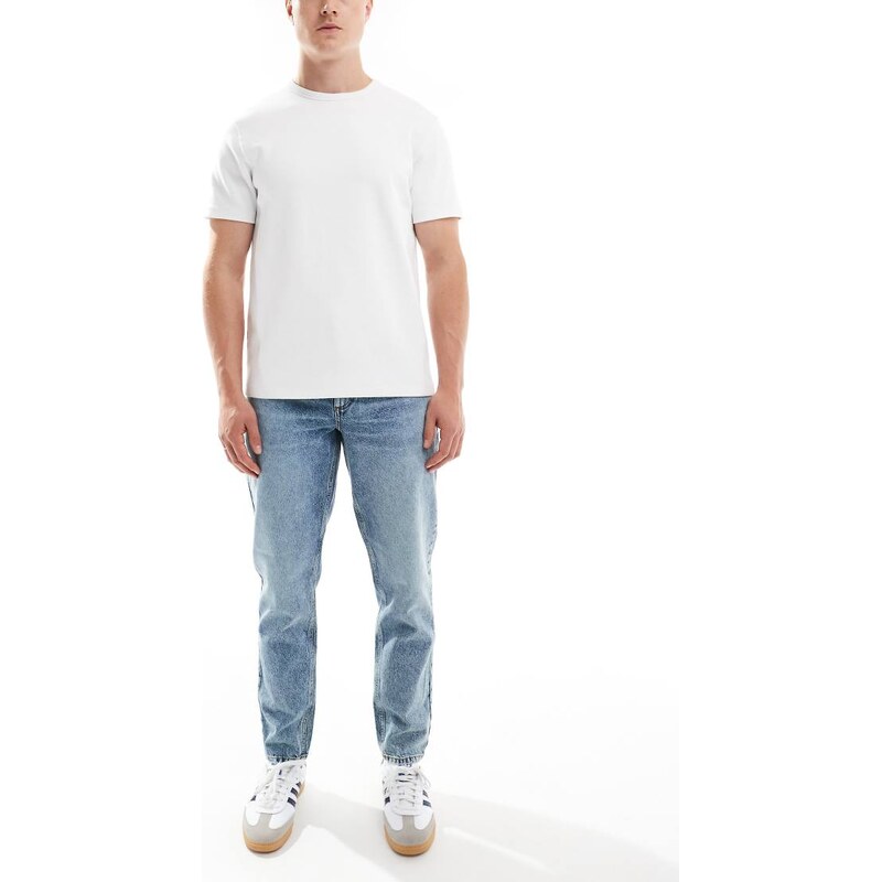 ASOS DESIGN tapered fit jeans in mid wash blue