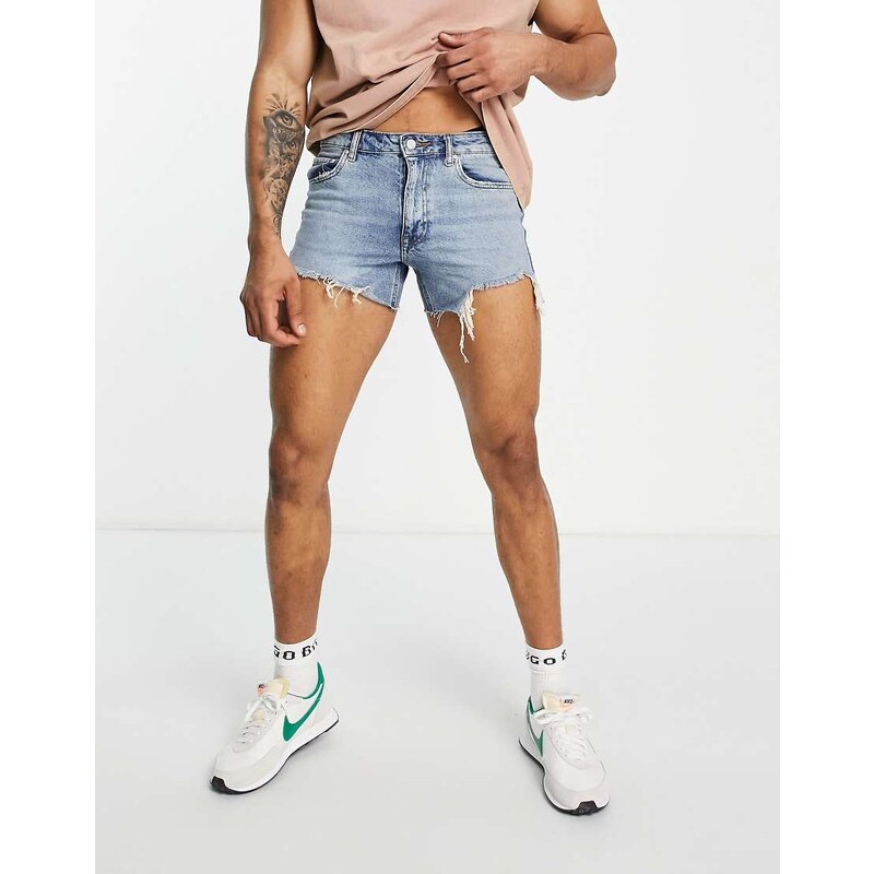 ASOS DESIGN shorter length denim shorts in 90s mid wash with rip