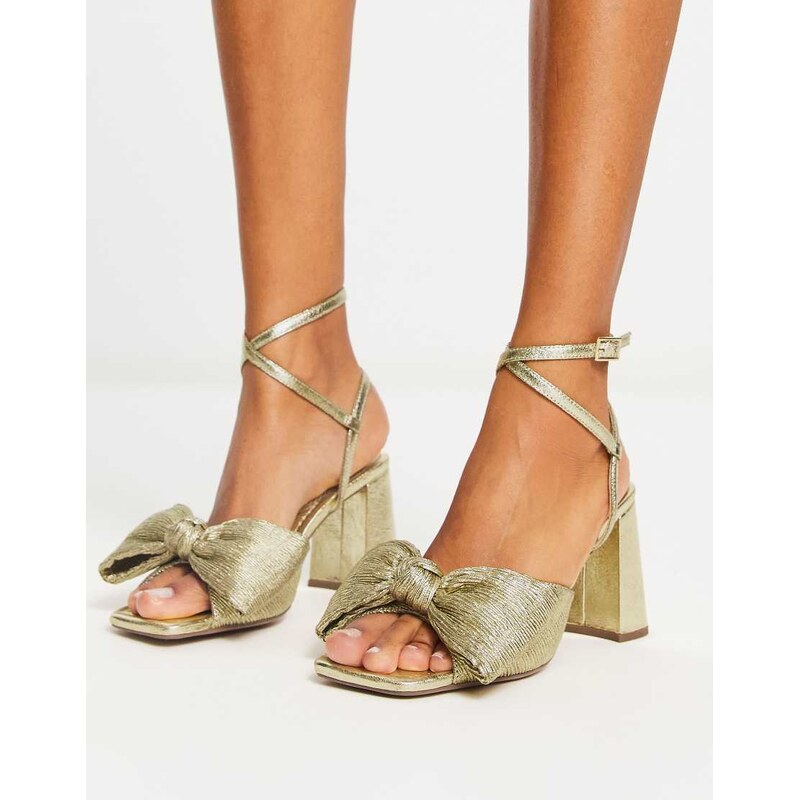 ASOS DESIGN Hitched bow detail mid block heeled sandals in gold 100045804