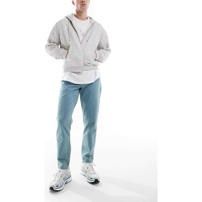 ASOS DESIGN tapered jeans in tinted light wash blue