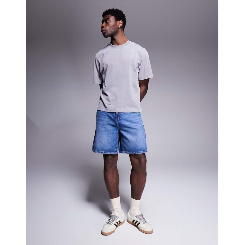 ASOS DESIGN standard length denim jort in mid wash blue