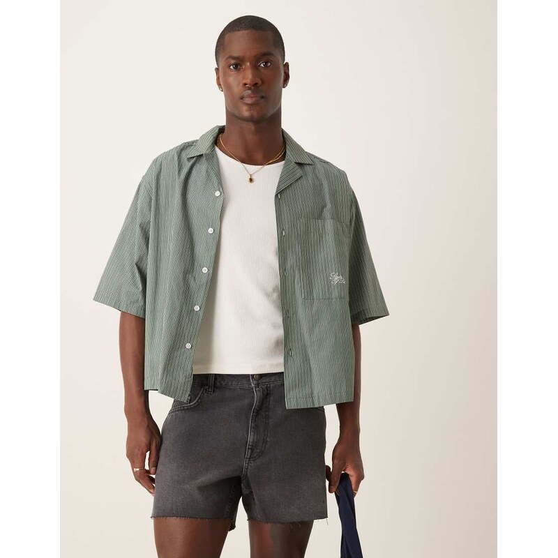 ASOS DESIGN shorter length slim denim shorts with rip detail in