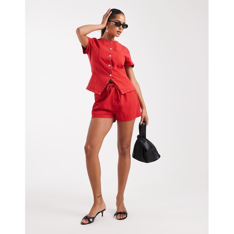 ASOS DESIGN jogger style denim pull on short in red