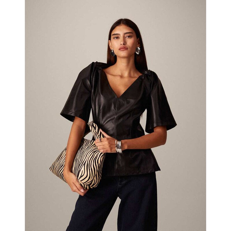 ARRANGE leather twist shoulder top in black 111000507