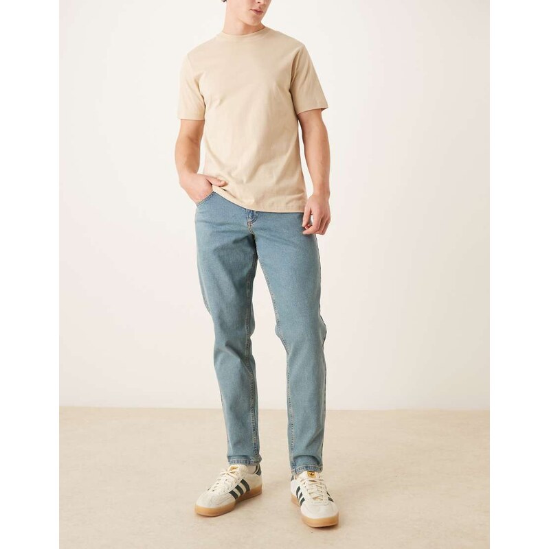ASOS DESIGN stretch tapered jeans in tinted light wash blue