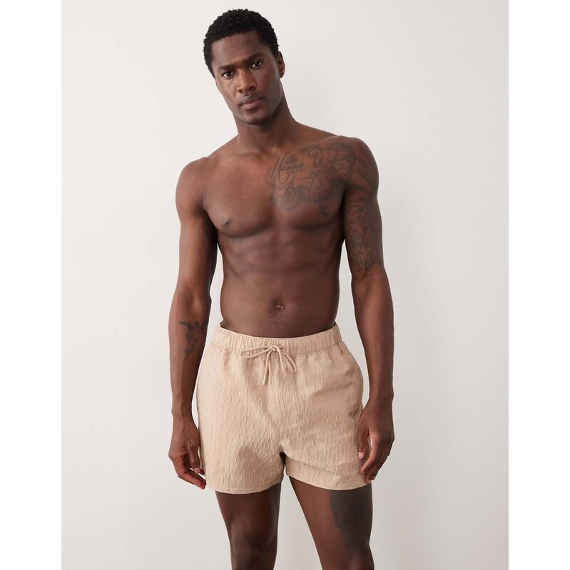 ASOS DESIGN textured swim shorts in short length in beige