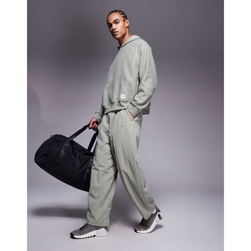 Nike Training Athletic Club badge logo track pants in grey