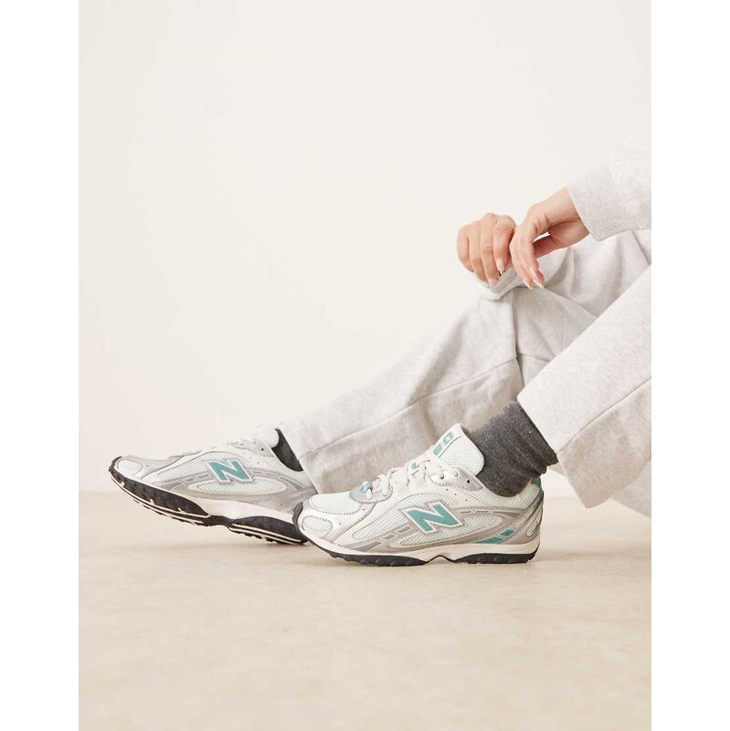 New Balance 204L trainers in silver metallic and blue