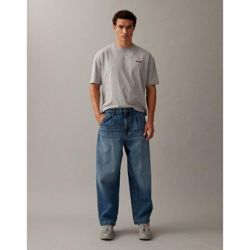 ASOS DESIGN relaxed tapered jeans in mid wash blue with pleats