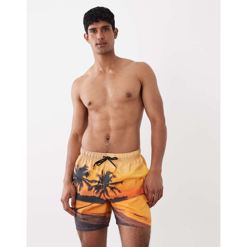 ASOS DESIGN swim shorts in mid length with beach sunset print in