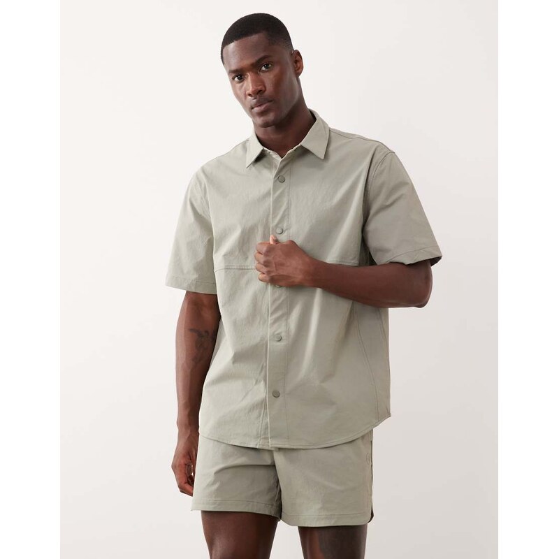 ASOS DESIGN motionMAX relaxed shirt with side pockets in sage