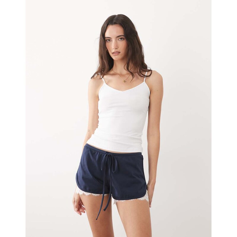 ASOS DESIGN jersey shorts with lace under layer in navy