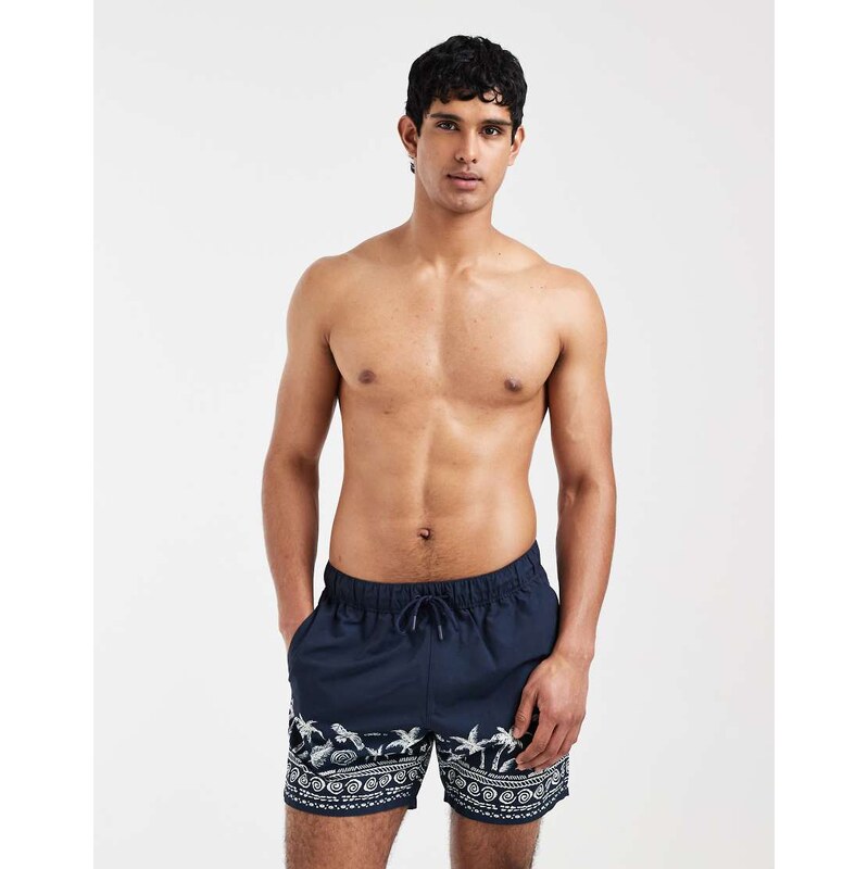 ASOS DESIGN swim shorts in mid length with placement print in navy