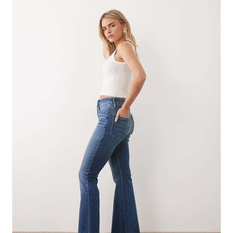 Good American petite frayed hem flare jeans in mid blue wash 115195167