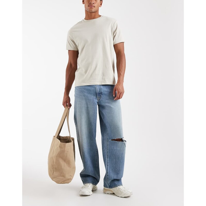 Levi's 578 baggy jeans with ripped knee in mid blue