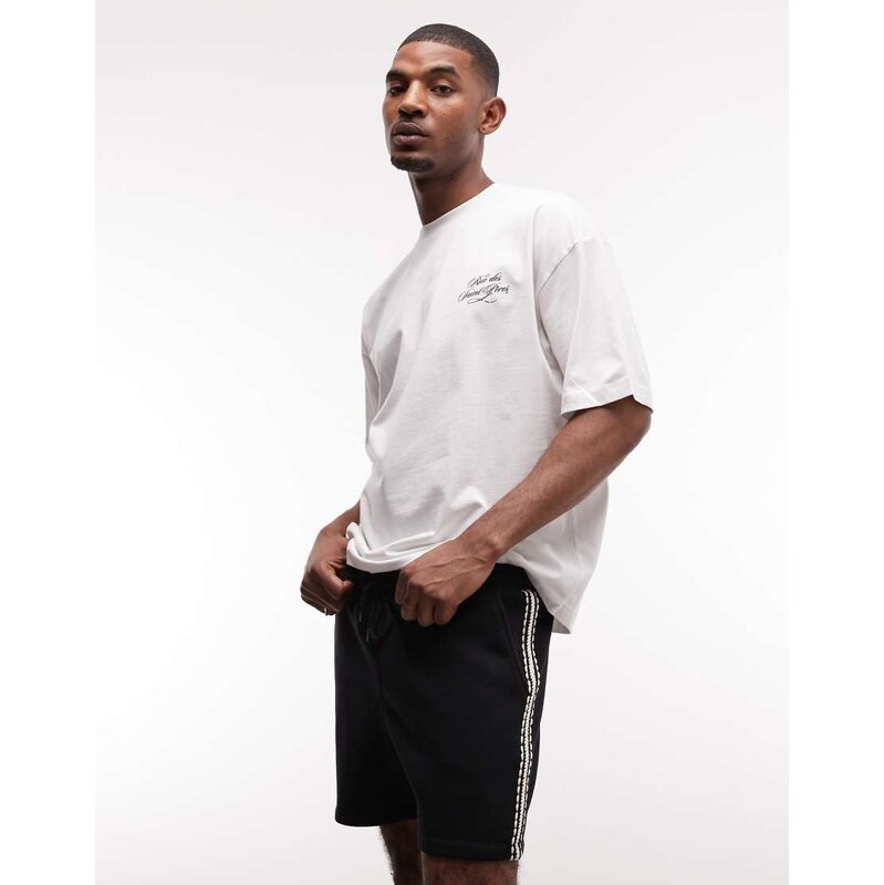 ASOS DESIGN oversized jersey shorts with tape detail in black