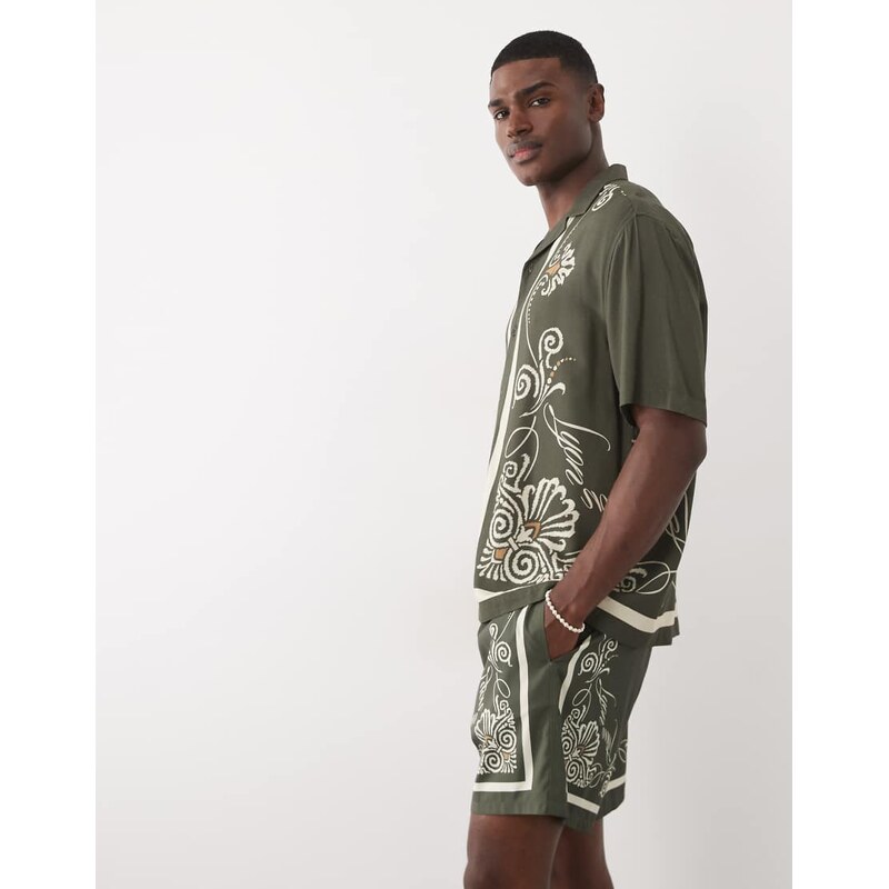 ASOS DESIGN co-ord swim shorts in short length with border print in green-Black