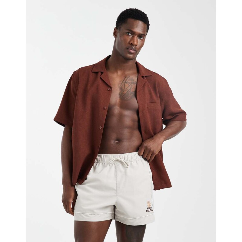 ASOS DESIGN swim shorts in short length with embroidery in beige