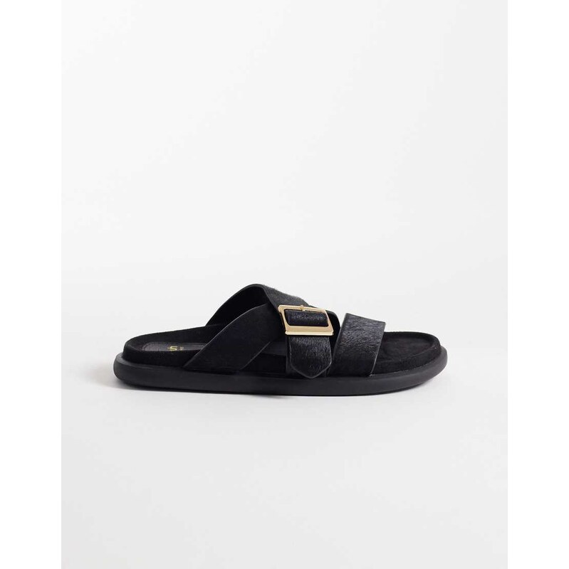 Schuh Tear cross over flat sandal with buckle detail in black pony 115609929