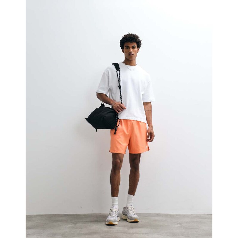 Nike Club Woven shorts in orange