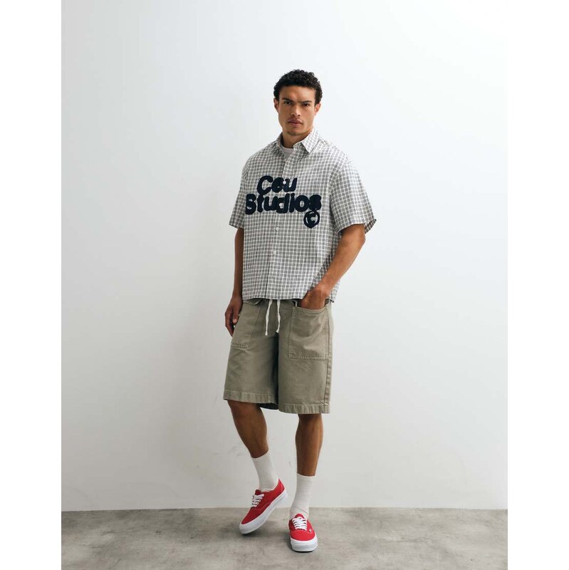 ASOS DESIGN loose denim cargo jorts in khaki with vintage wash