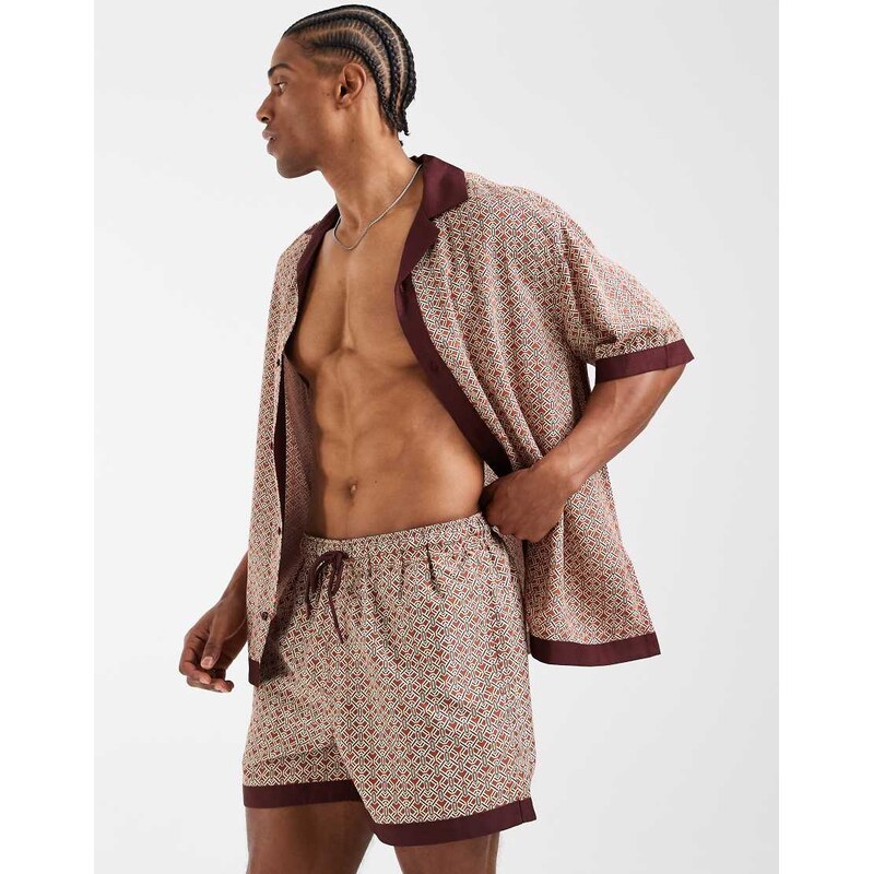 ASOS DESIGN co-ord swim shorts in short length in orange geo