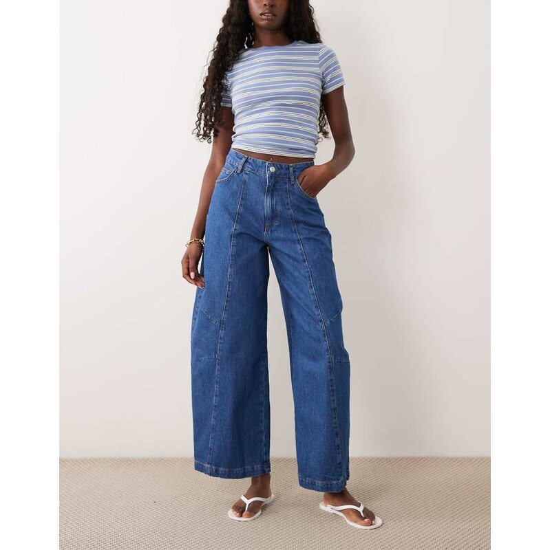 ASOS DESIGN curved yoke jeans with seam details in midwash blue