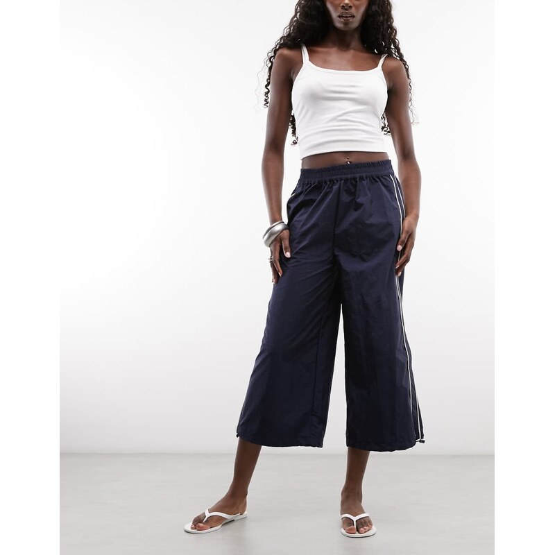 ASOS DESIGN cropped track pant in navy blue with ecru piping