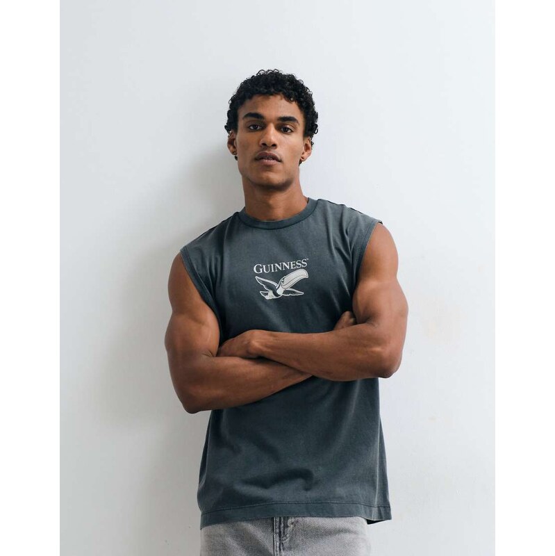 ASOS DESIGN oversized tank with Guinness print in Washed Black
