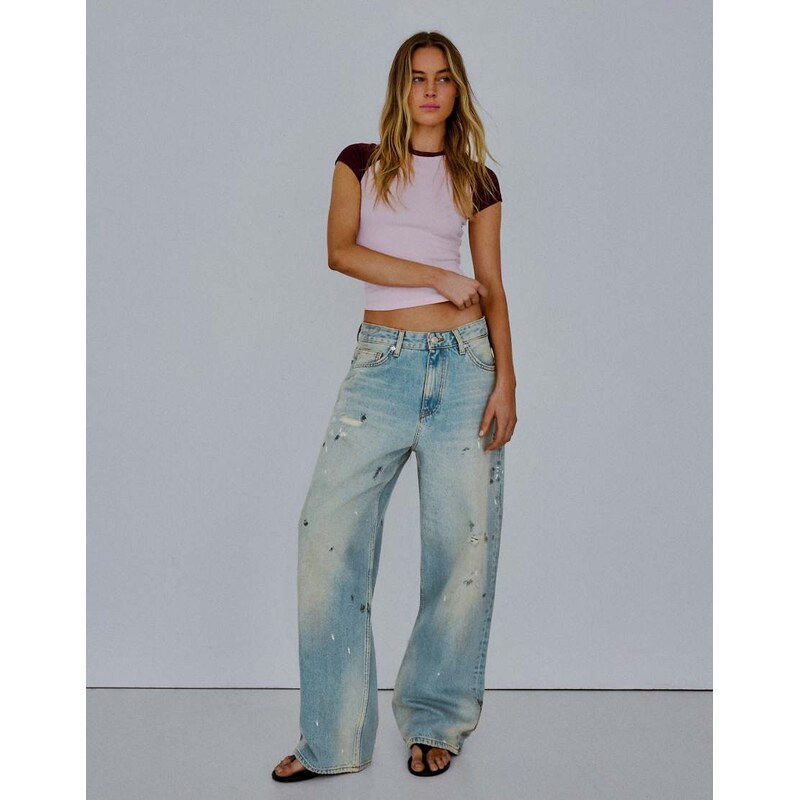 Bershka Loose fit paint-effect jeans in mid blue