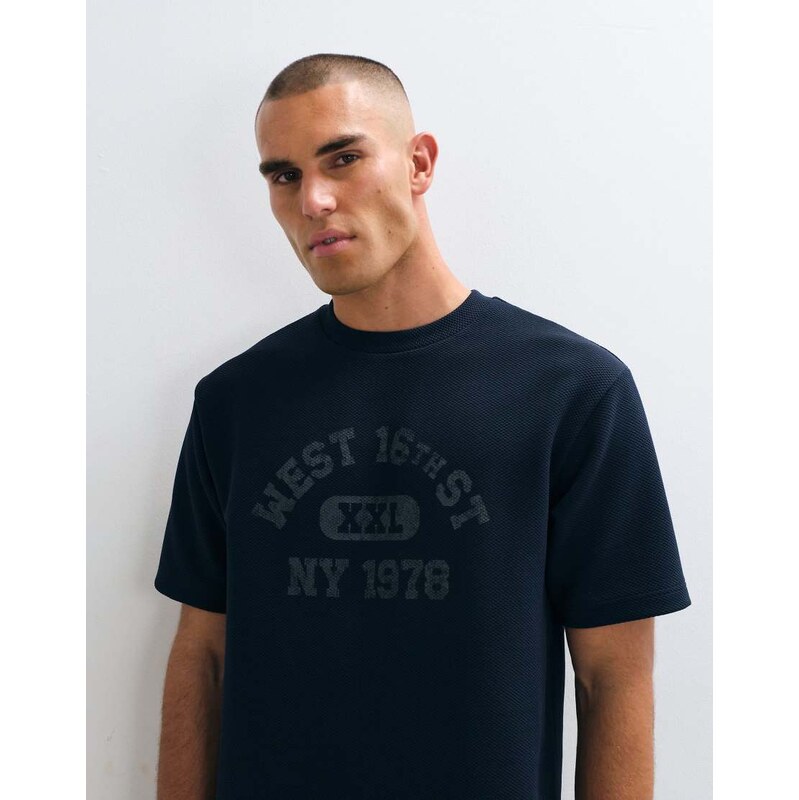 ASOS DESIGN relaxed t-shirt with collegiate graphic in navy