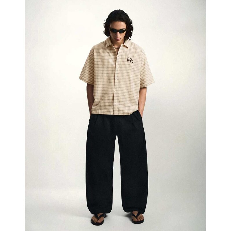 Bershka Darted barrel leg trousers in black