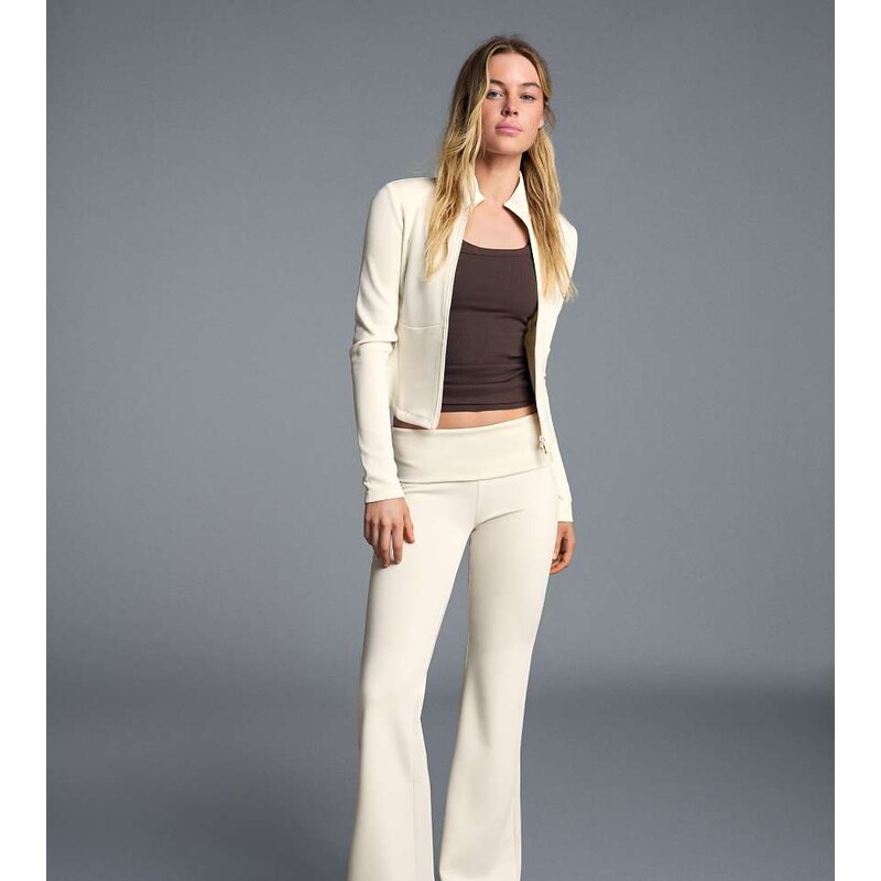 Bershka Petite flared trousers in ecru-White