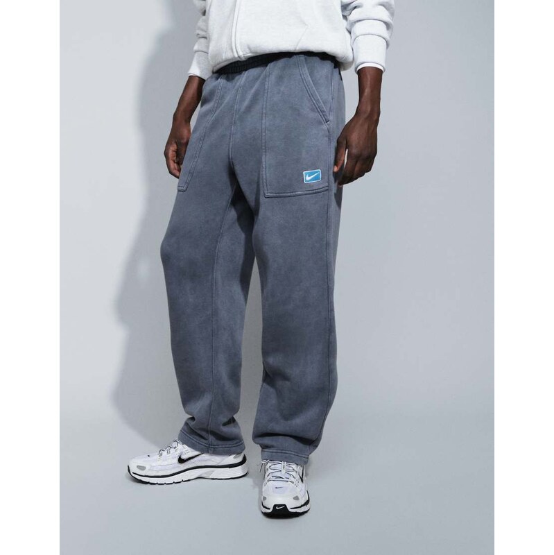 Nike spray graphic open hem joggers in washed black