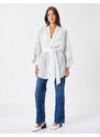 Koton The Belted Waist Kimono has a loose fit.